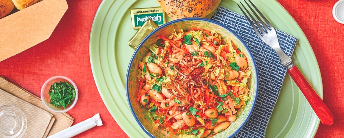Vietnamese Veggie Salad in a bowl on a plate with a roll