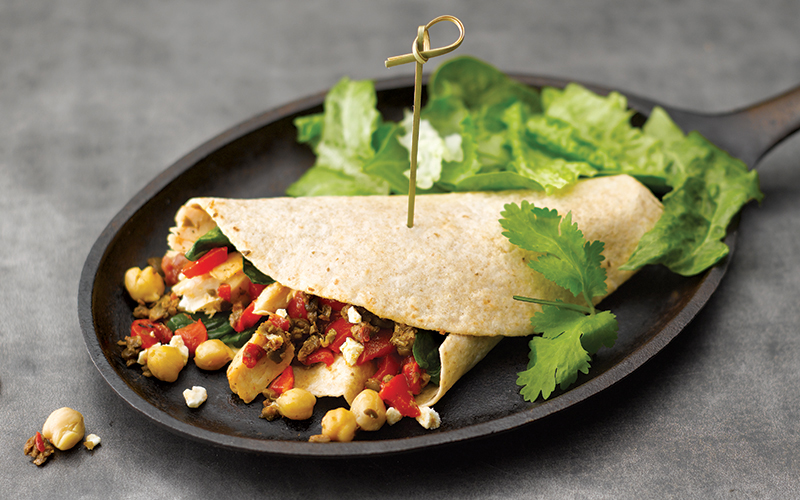 Mediterranean Chicken & Garbanzo Bean Wrap on a cast iron skillet with lettuce