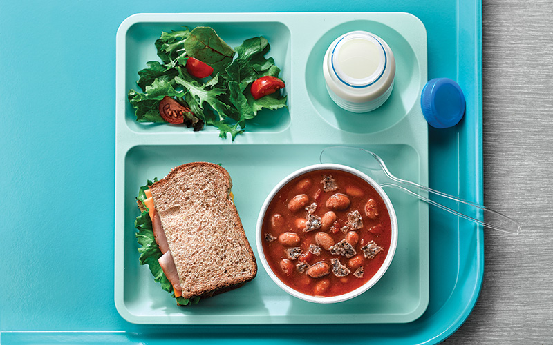 Bush's Best® Easy Entrées® Texas Ranchero Pinto Beans, tomatoes, veggie stock and crushed Bush's Best® Black Bean Chips create a quick and easy foodservice recipe for K-12 lunchrooms.